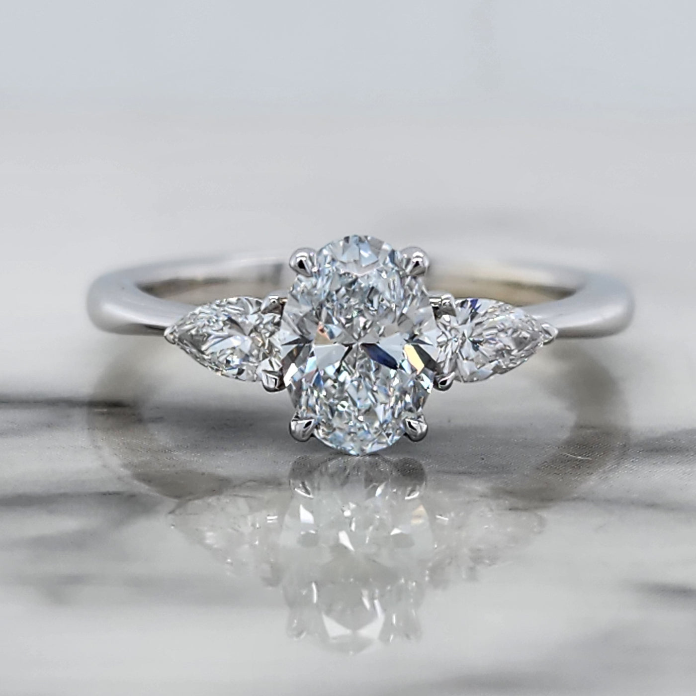 White Gold 3 Stone Engagement Ring With Oval And Pear Shaped Diamonds