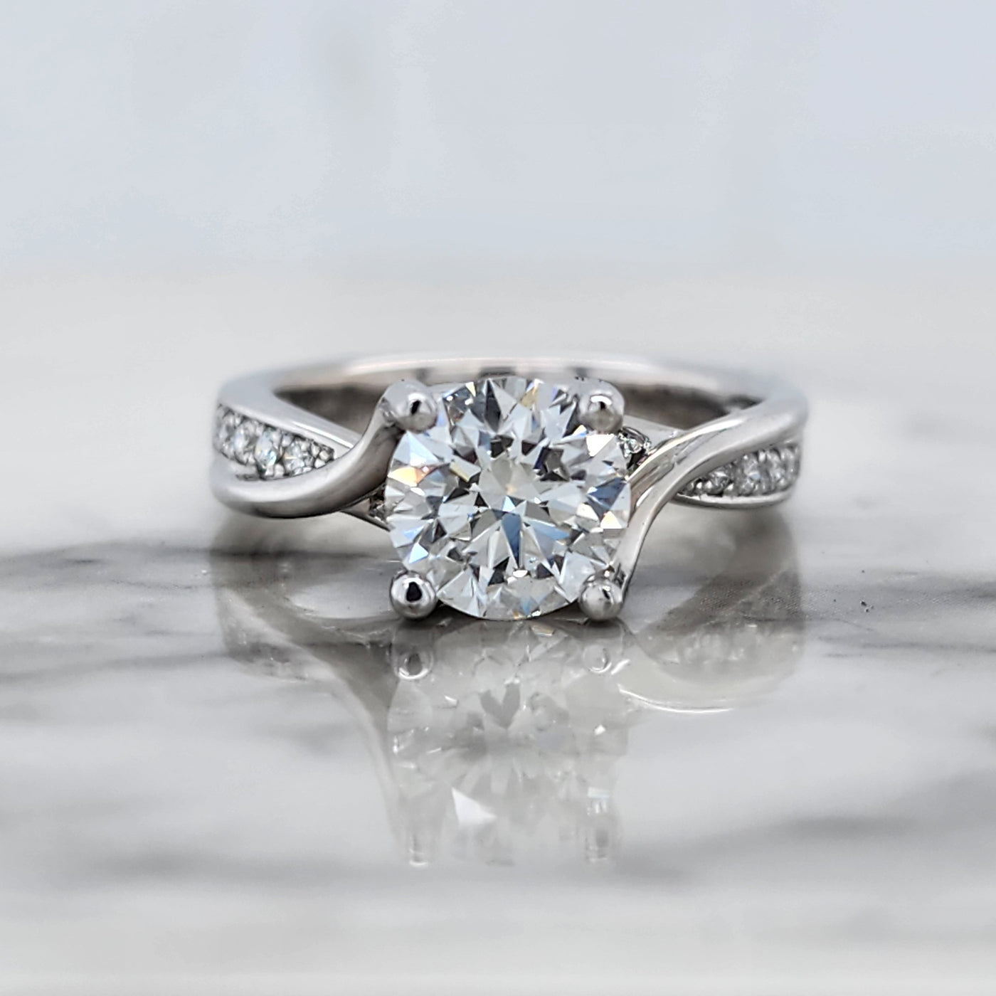 White Gold Bypass Engagement Ring With Round Center and Round Accent Diamonds