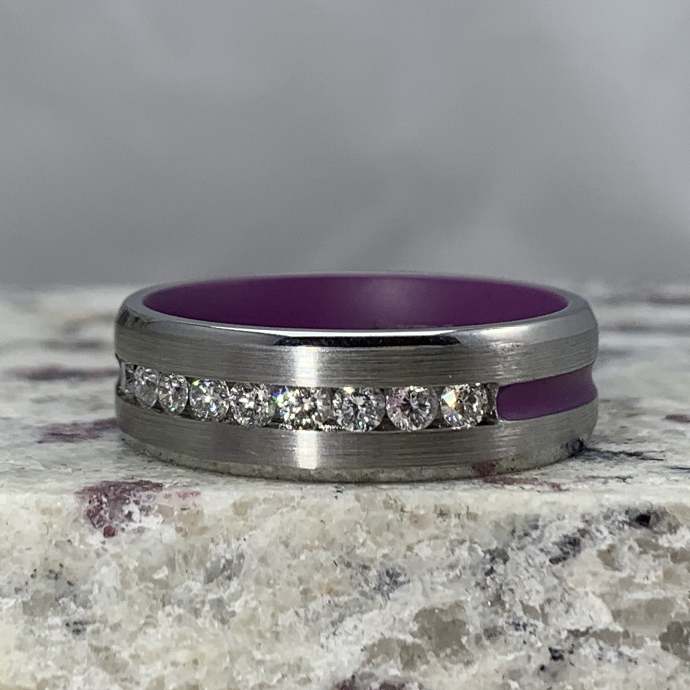 white gold band with purple sleeve and inlay and channel set diamonds