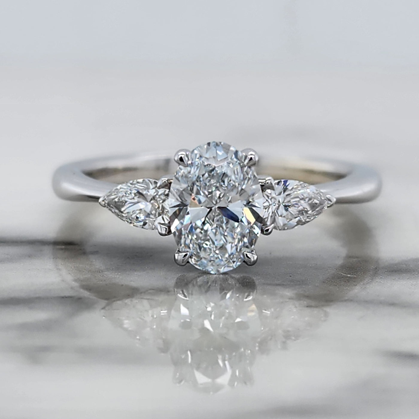 White Gold 3 Stone Engagement Ring With Oval And Pear Shaped Diamonds