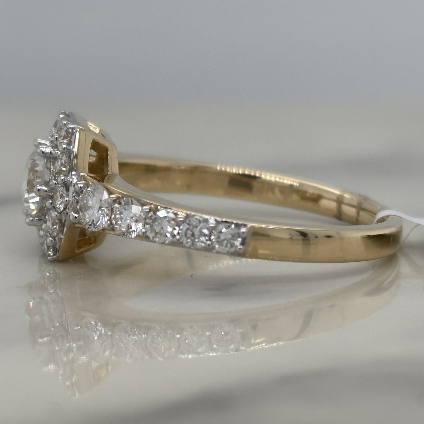 yellow gold hexagon halo engagement ring with round center stone and round accent diamonds