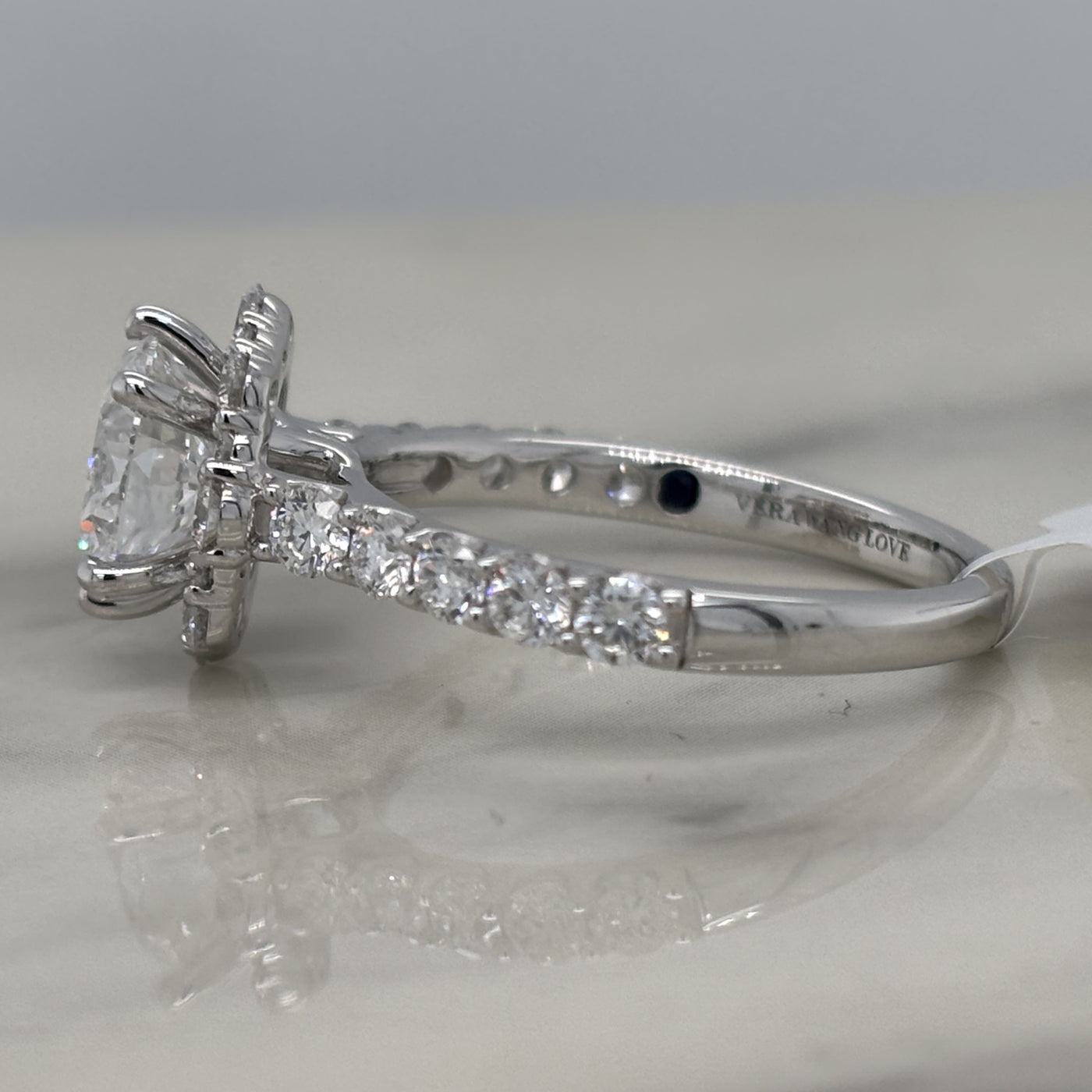 white gold round engagement ring with floral shaped halo and accent diamonds