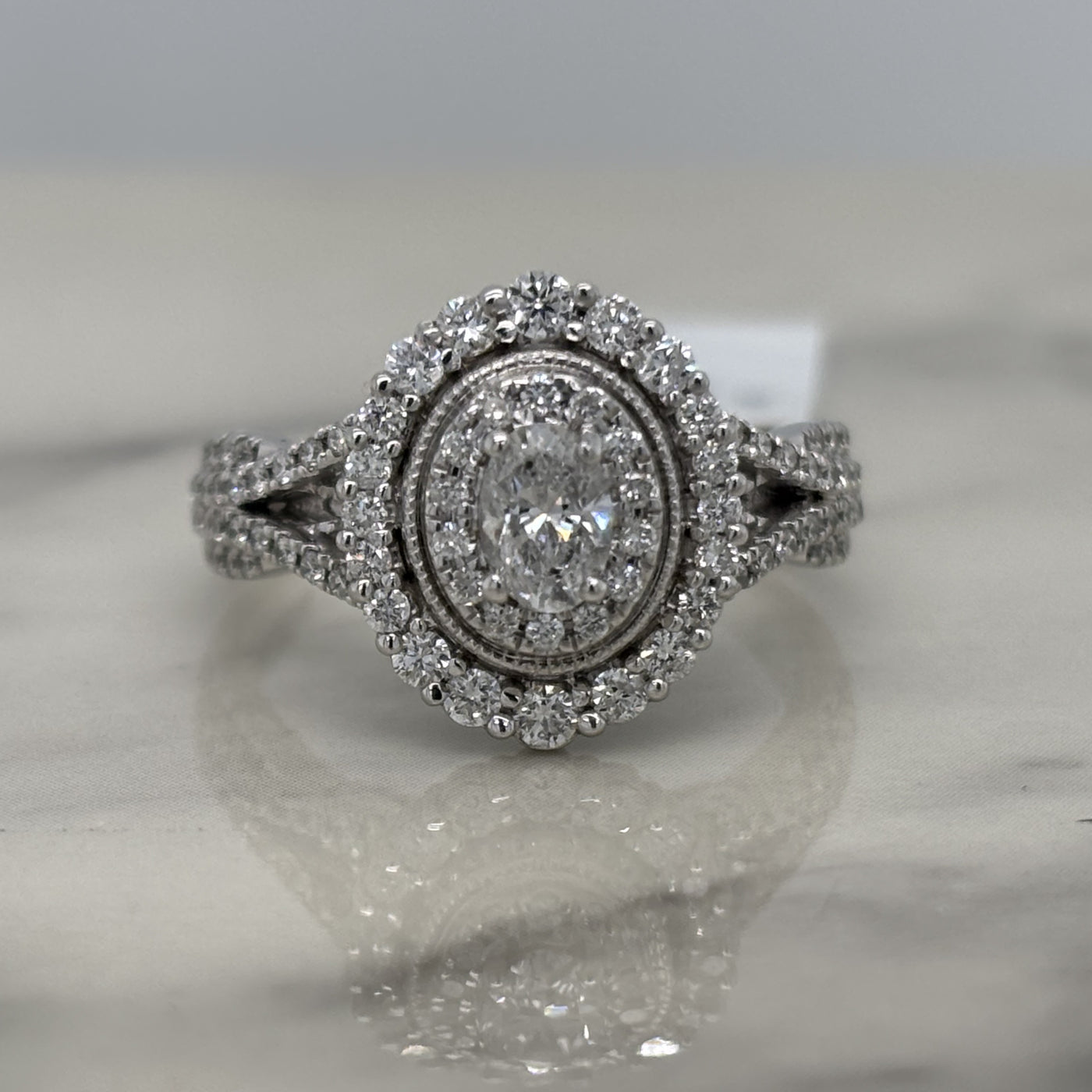 white gold oval engagement ring with double halo and accent diamonds