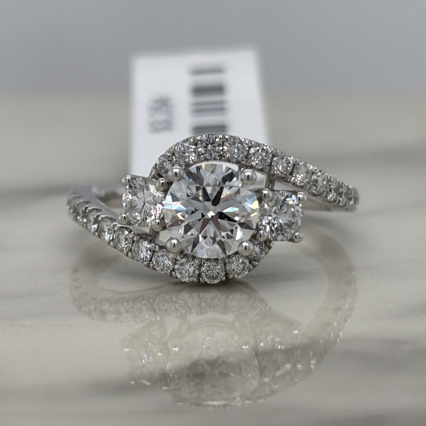 white gold 3 stone round engagement ring with accent diamonds