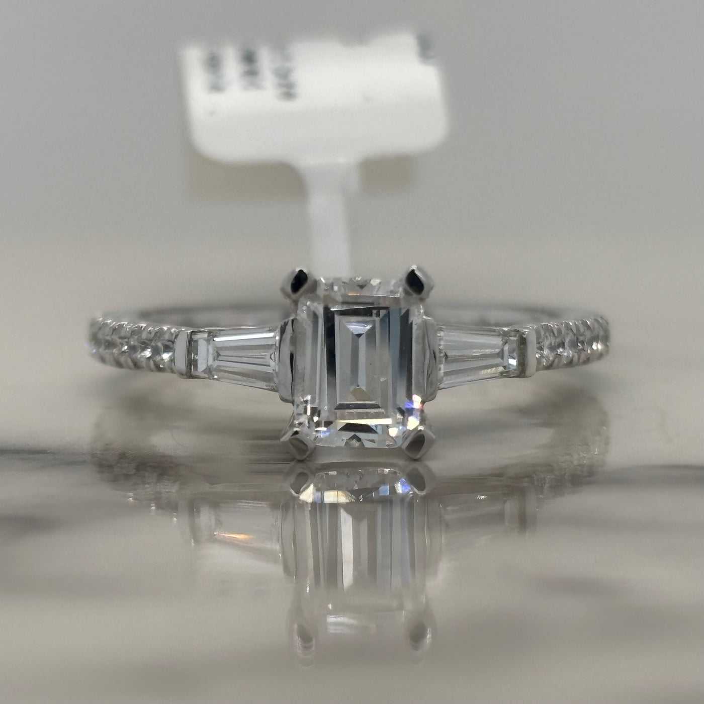 White Gold Emerald cut Engagement ring with baguette side stones and round accent diamonds