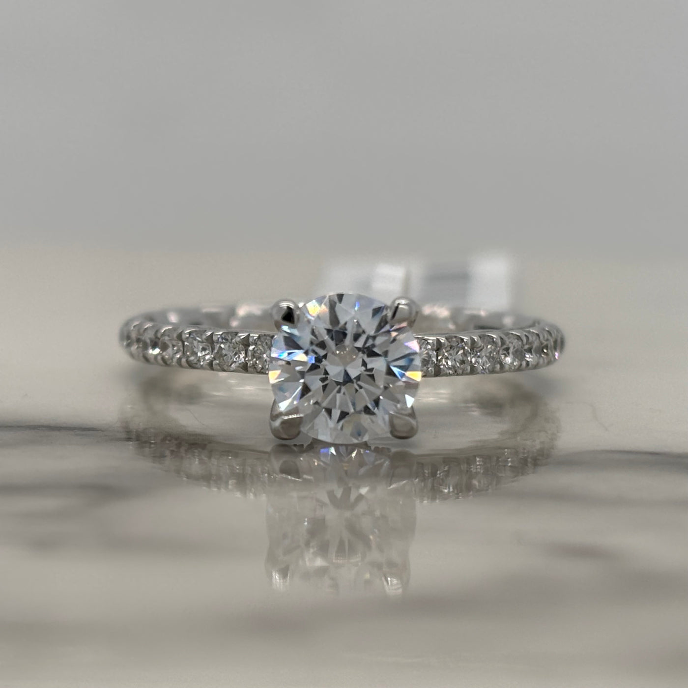 14k white gold round engagement ring with round accent diamonds