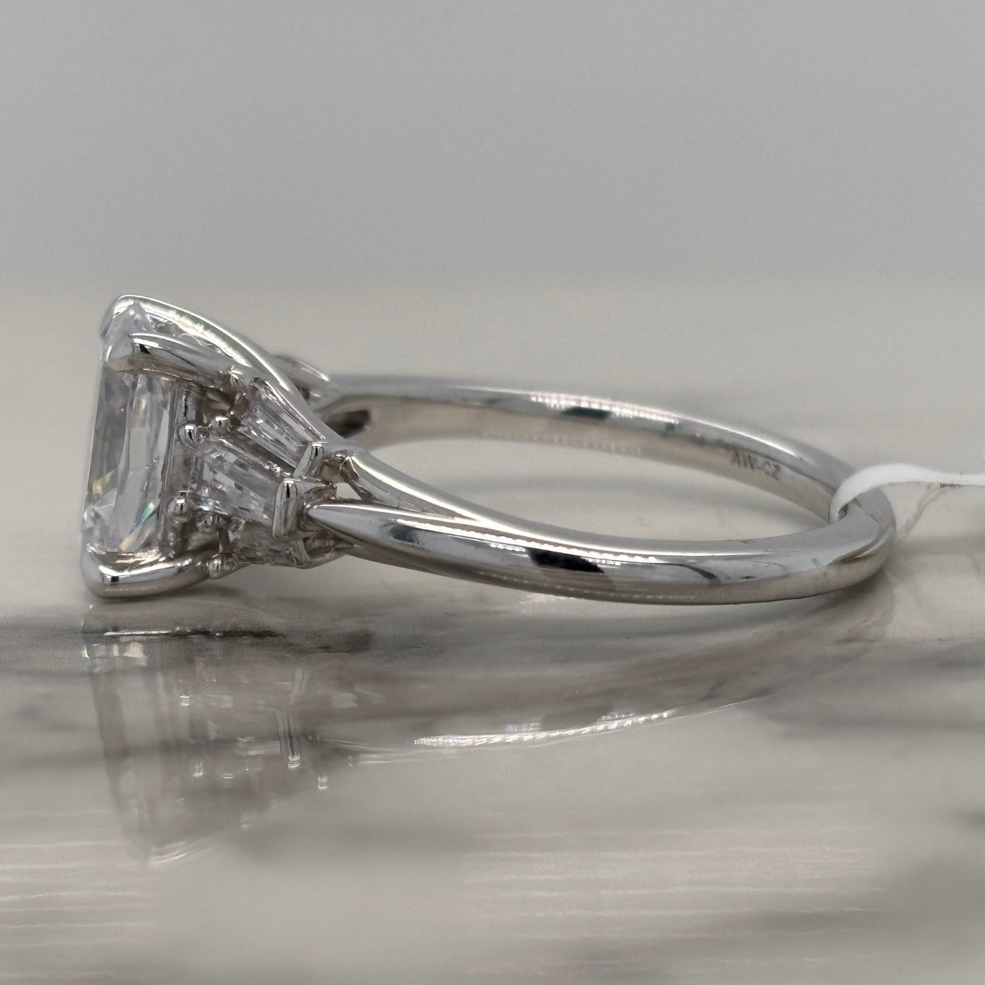 white gold oval engagement ring with tapered baguette side stones