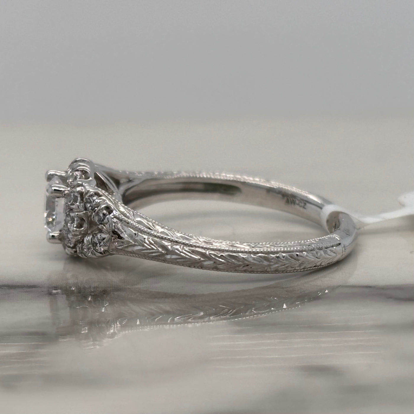 white gold floral inspired engagement ring with halo and accent diamonds