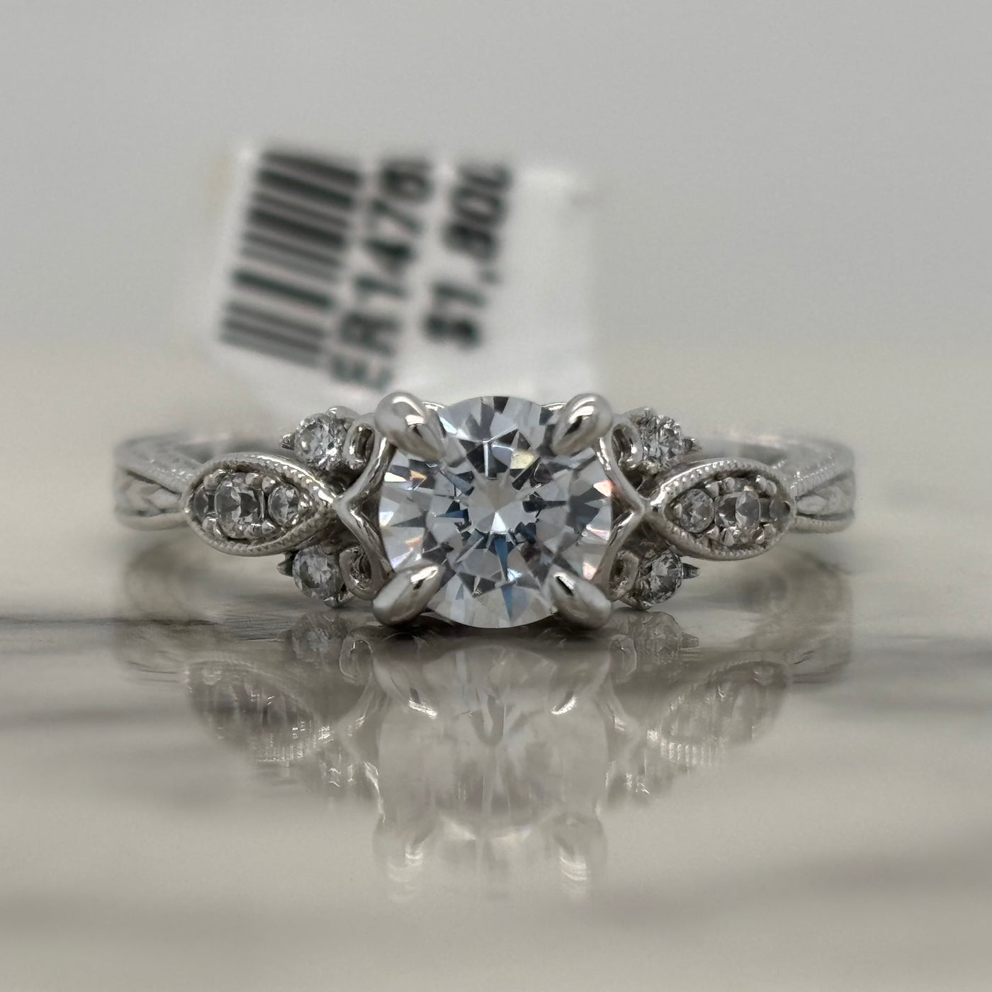 white gold round engagement ring with floral milgrain detail and accent diamonds
