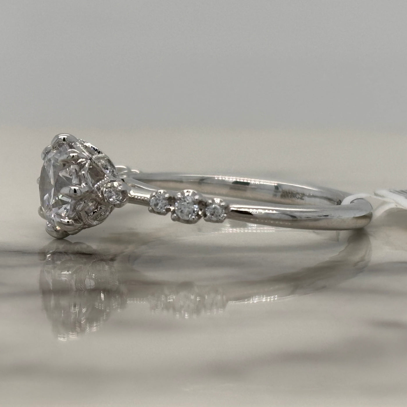 white gold round 8 prong engagement ring with accent diamonds and floral detail
