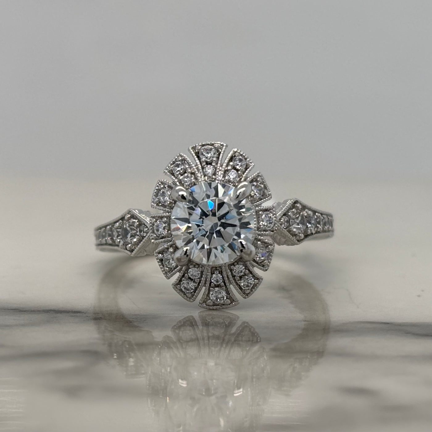 white gold round art deco engagement ring with oval halo and diamond accent stones