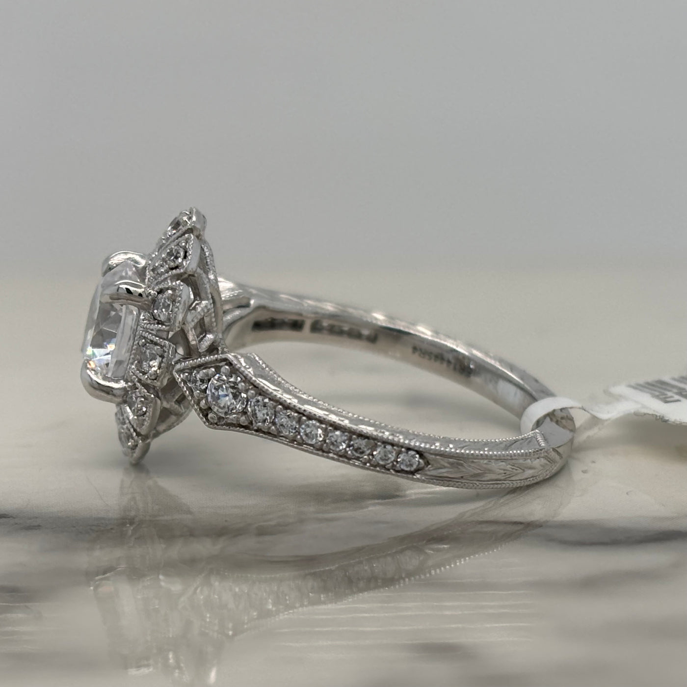 white gold round art deco engagement ring with oval halo and diamond accent stones