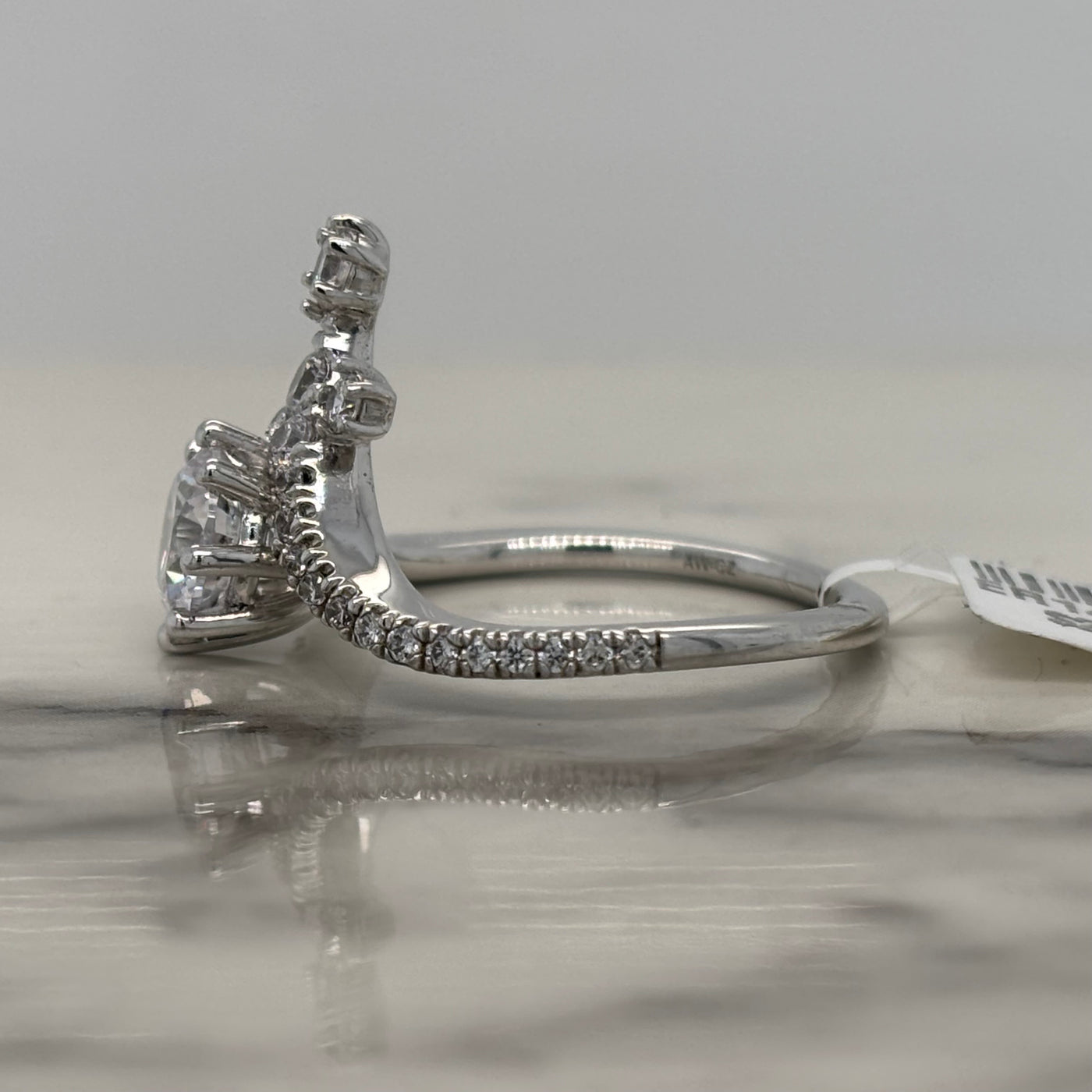 white gold round chevron engagement ring with round accent diamonds