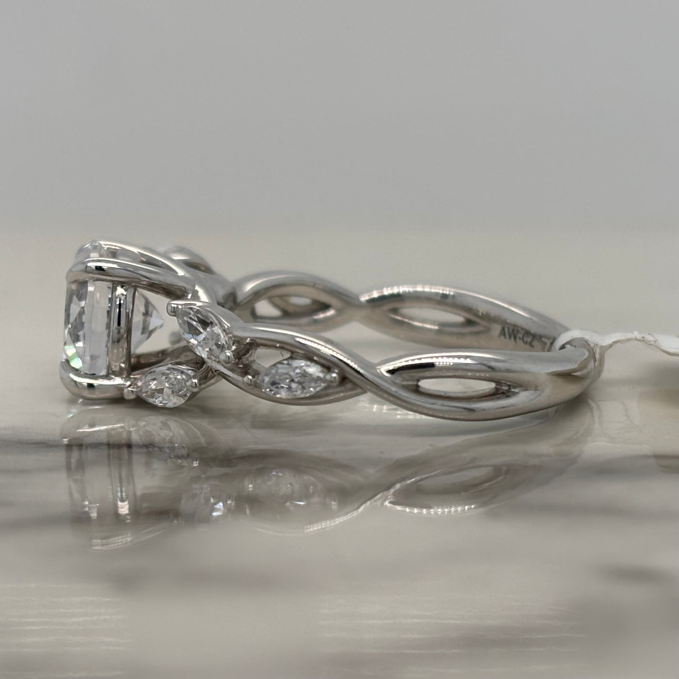 White Gold Round Engagement Ring With Floral Marquise Diamond Accents and Twist Design