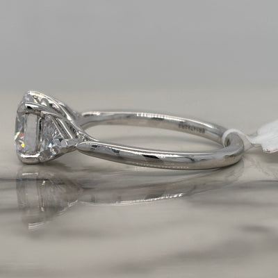 White Gold Round Three Stone Engagement Ring With Trillion Side Stones
