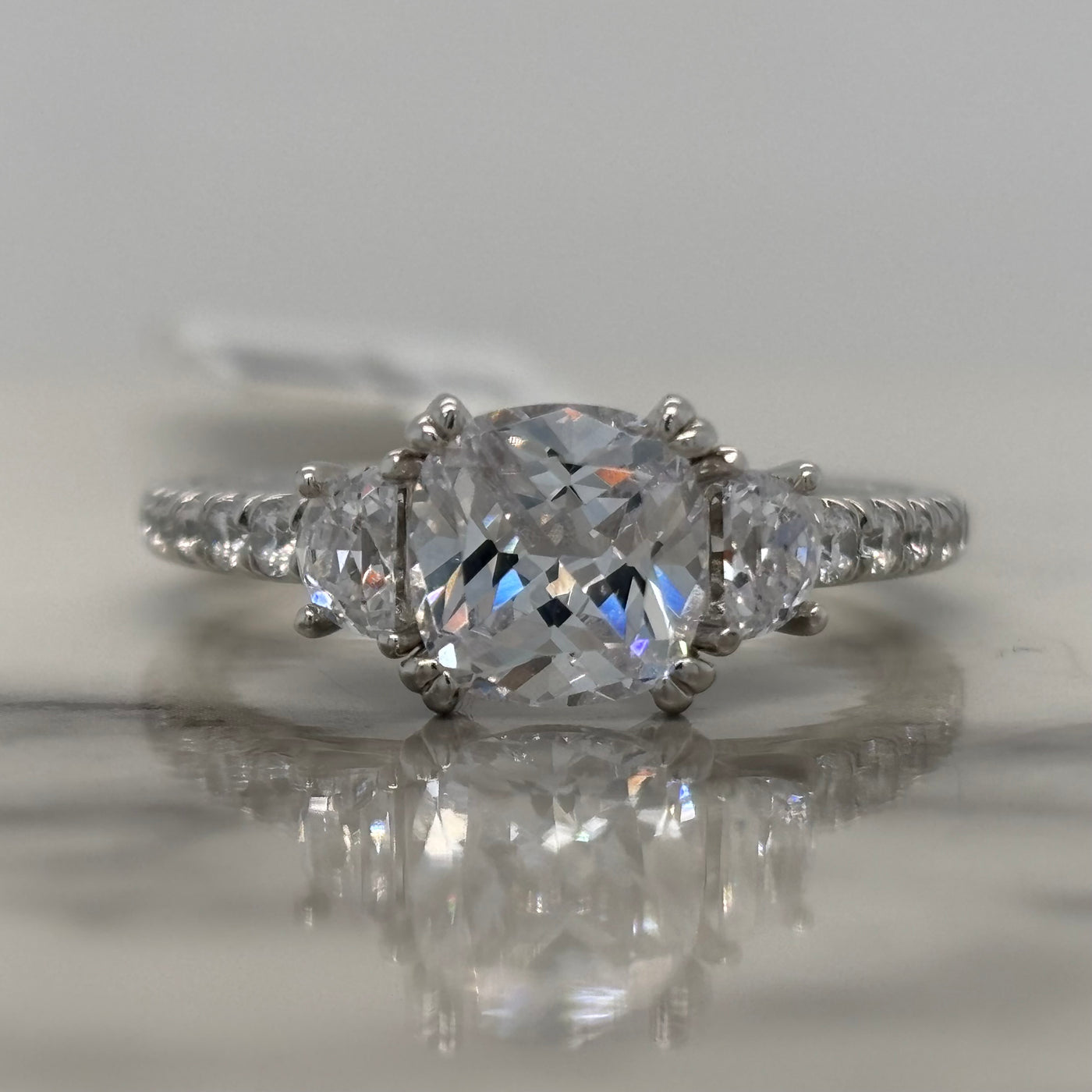 White Gold Cushion Cut Engagement Ring With Crescent Side Diamonds and Round Accents