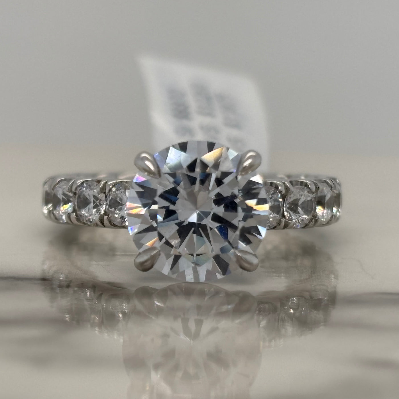 White Gold Round Engagement Ring With Hidden Halo and Round Accent Stones and Quilted Inside Design