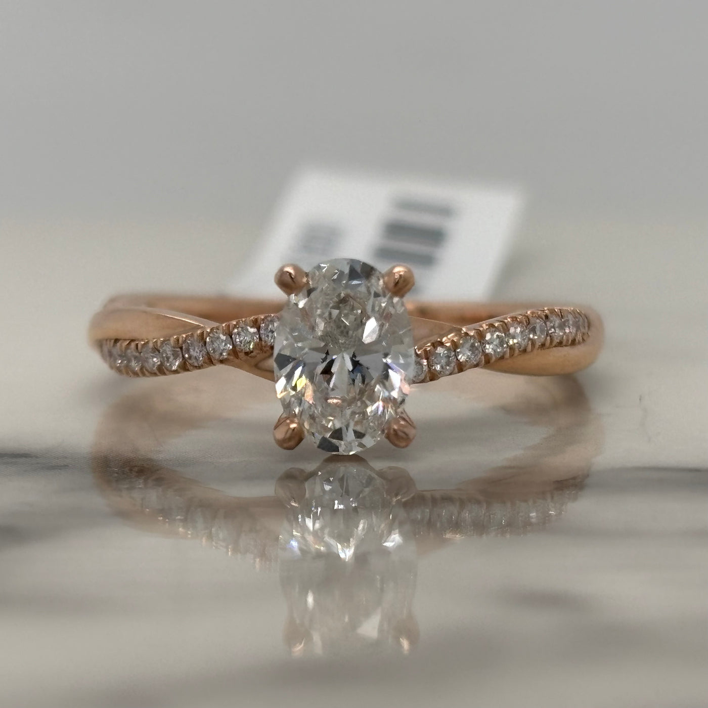 Rose Gold Oval Engagement Ring With Twist Design and Accent Diamonds