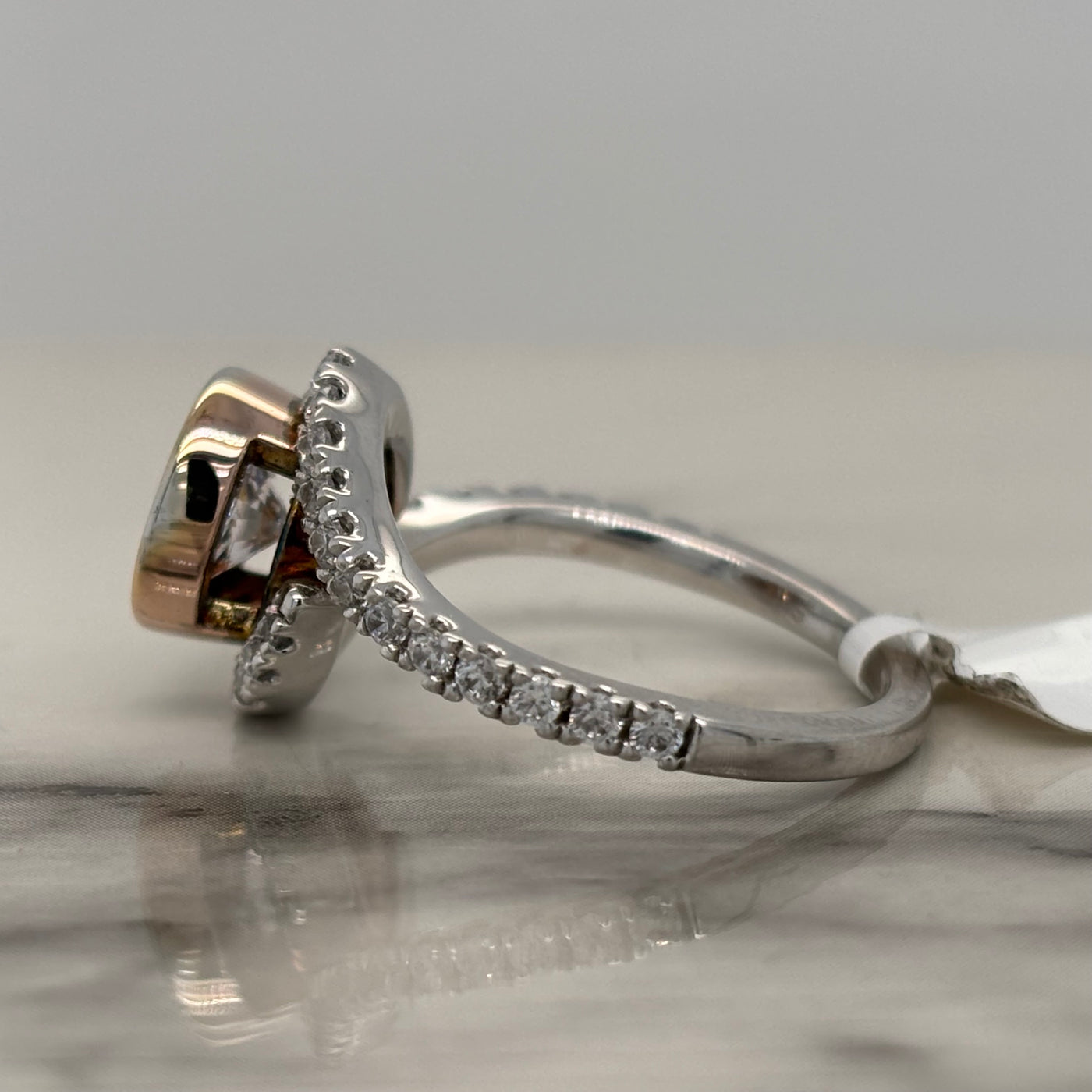 2 Tone White And Rose Gold Round Bezel Set Engagement Ring With Bypass Design and Accent Diamonds
