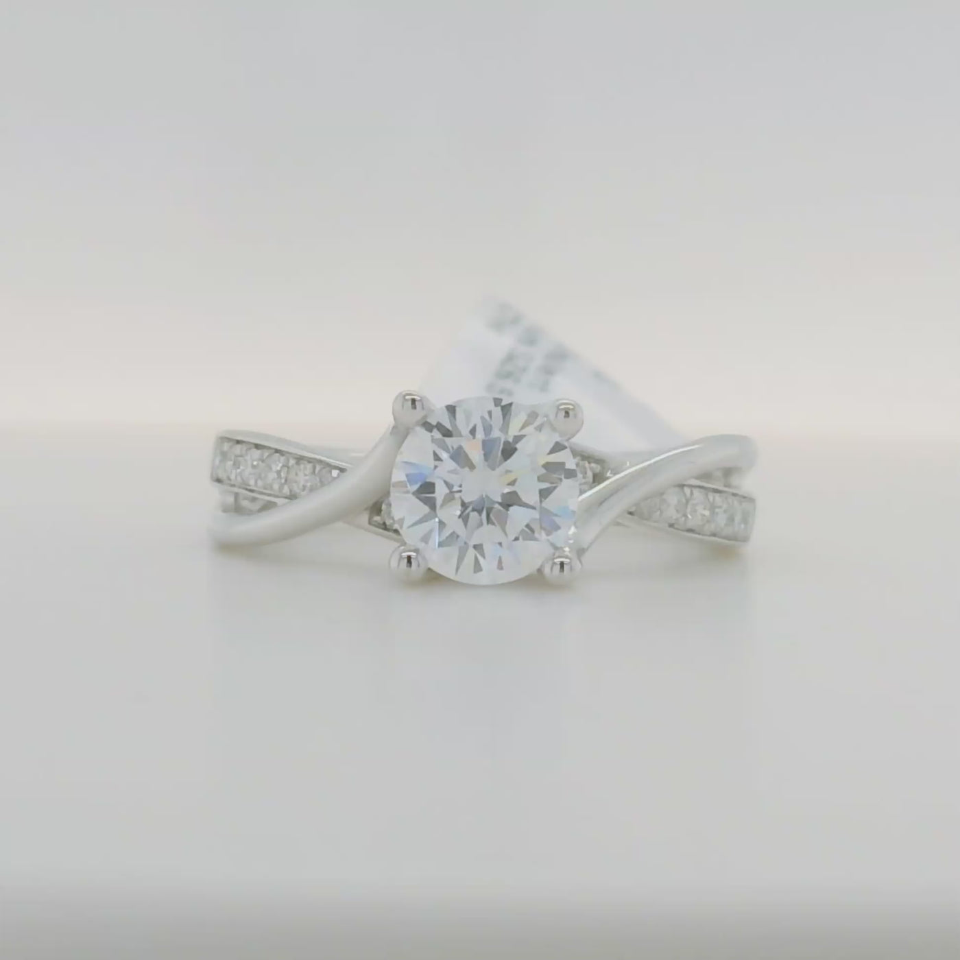 white gold semi mount engagement ring with round diamond accent stones and twist design