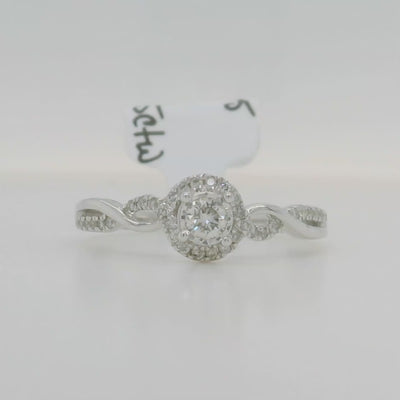 white gold engagement ring with round center stone and halo with accent diamonds and twist design