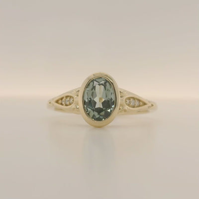 yellow gold oval green sapphire engagement ring with accent diamonds