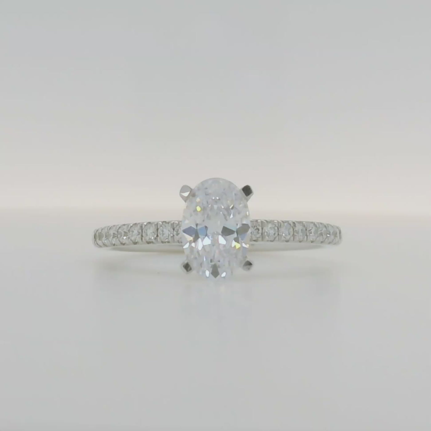 14k white gold semi mount engagement ring with oval center stone and diamond accent stones